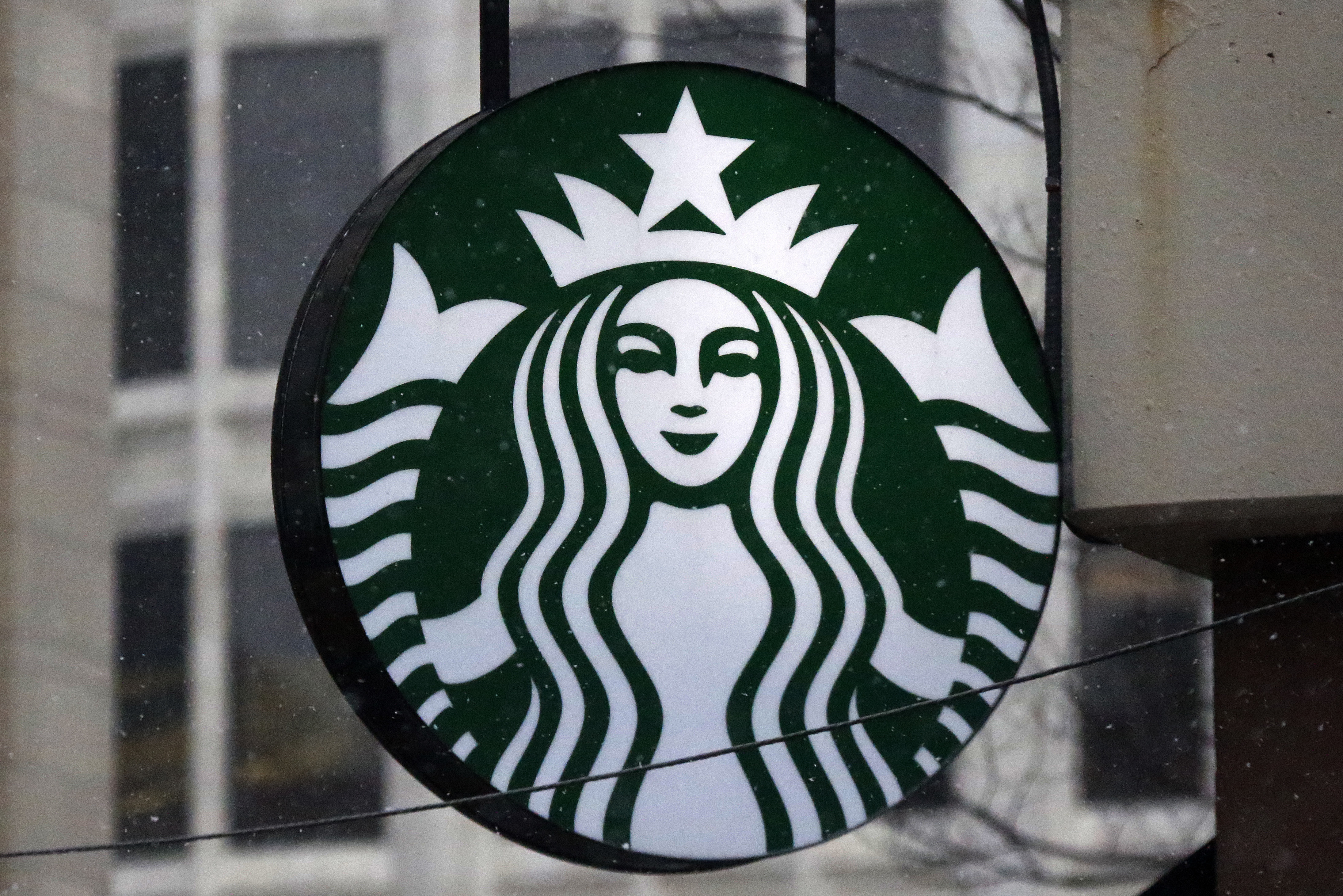 FILE - The Starbucks logo is seen, March 14, 2017, on a shop in downtown Pittsburgh. Business closings on Christmas Eve are less common than those on Christmas Day, but many large chains still cut back hours or close up shop early for the coming holiday. Many Starbucks locations will be open on Christmas Eve, Sunday, Dec. 24, 2023, but hours can vary. (AP Photo/Gene J. Puskar, File)